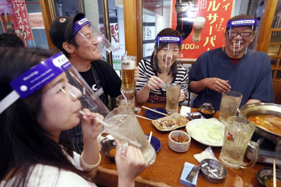 Japan: Customers wear face shields while visiting  ...