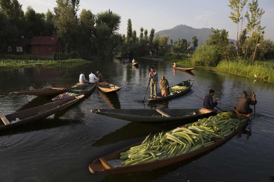 Images of the Day- Kashmir: Vendors carry vegetables on boats at a floating vegetable market in Dal Lake