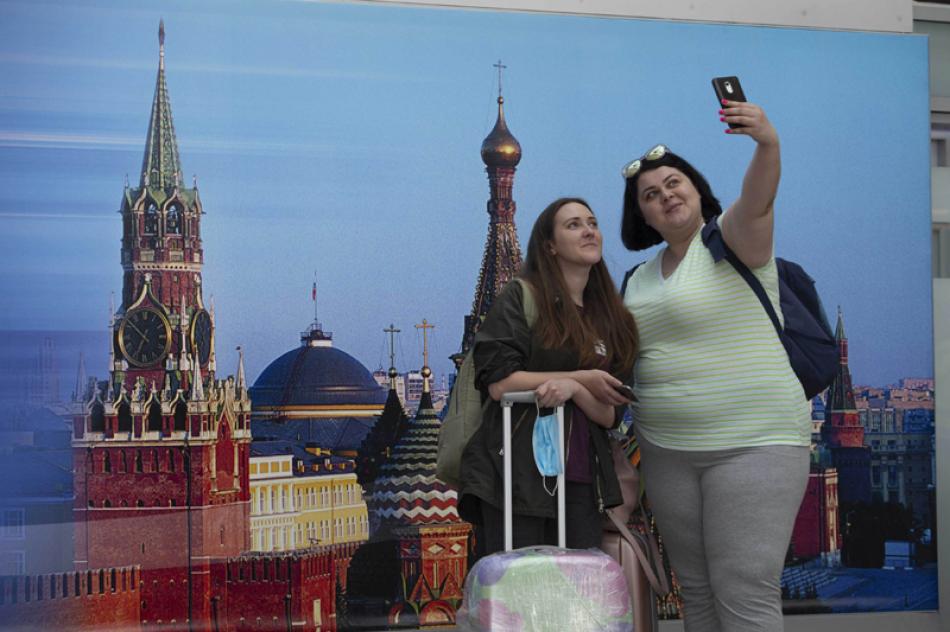 Passengers taking selfie at Sheremetyevo International Airport after Russia resumed air service partially