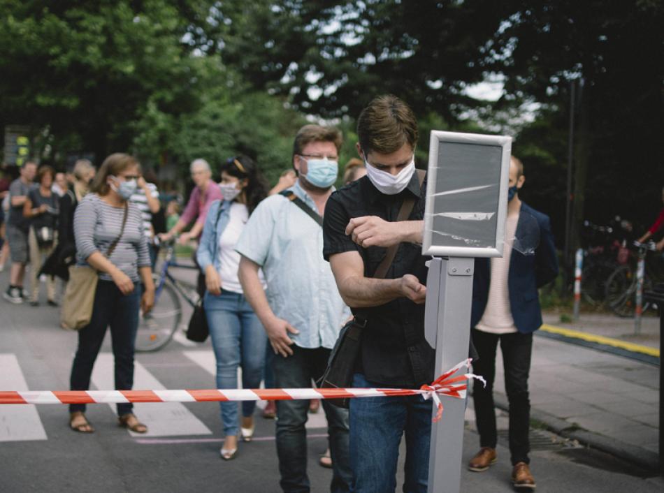 Images of the Day: Customers line up to sanitize hands before entering a beer garden in Germany