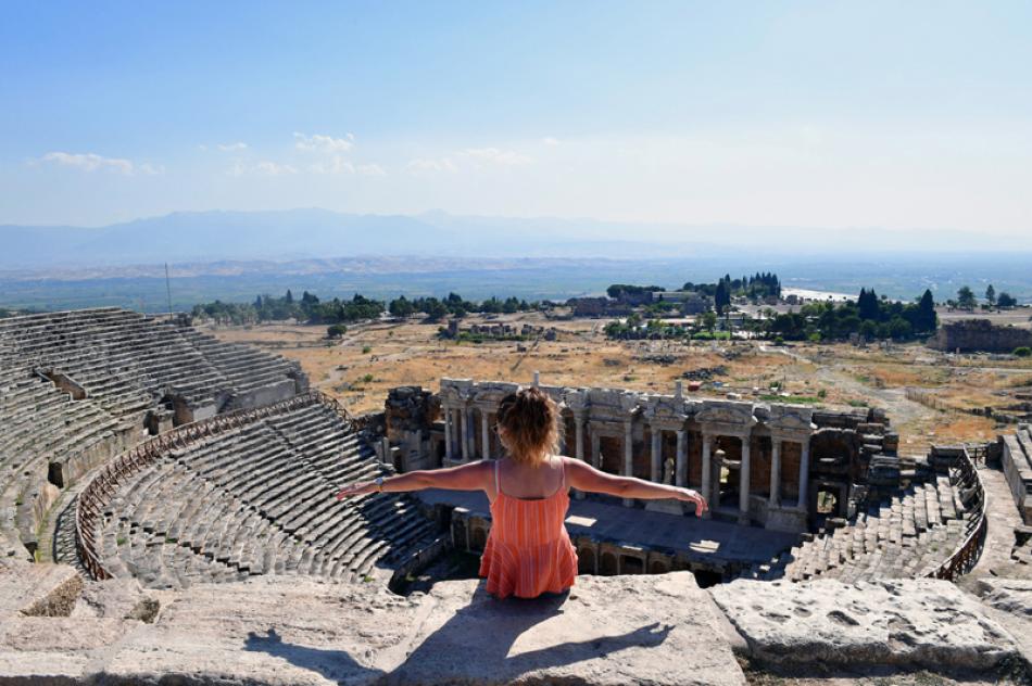Images of the Day:A visitor sits on the ruins of the ancient city of Hierapolis in Turkey.