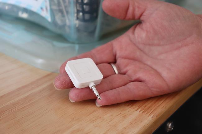 Sanders offers Square as an option for payment at her hair salon. Square is a financial services platform to help small-and medium-sized businesses to accept credit card payments and use phones or tablets as payment registers for a point-of-sale system.  Photo by Julianna M. Russ